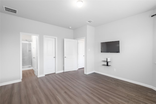 24511 Lorenzo Glaze Trl, Katy, TX 77493 - unfurnished bedroom with wood finished floors, baseboards, and ensuite bathroom