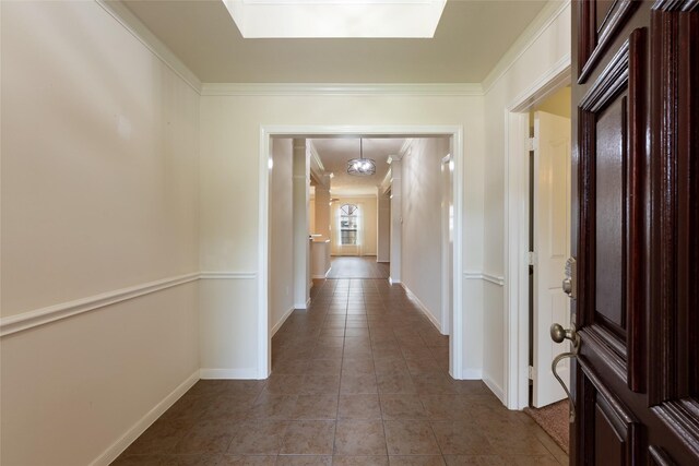 6723 Travis St, Manvel, TX 77578 - hall featuring light tile patterned floors, a skylight, crown molding, and baseboards