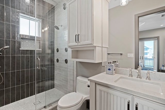 3835 Seabreeze Ln, Galveston, TX 77554 - full bathroom featuring plenty of natural light, a shower stall, toilet, and vanity