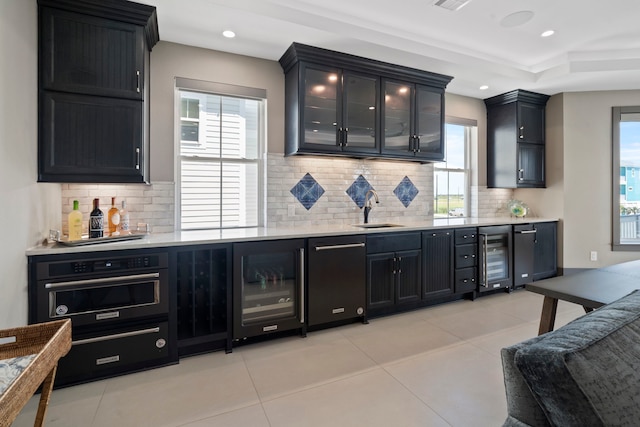 3835 Seabreeze Ln, Galveston, TX 77554 - indoor wet bar with wine cooler, light tile patterned floors, tasteful backsplash, and recessed lighting