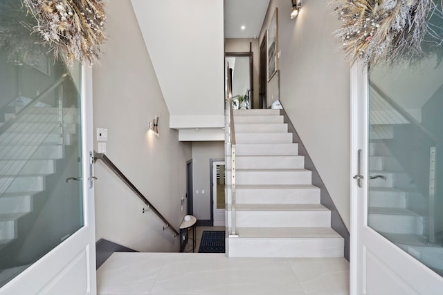 3835 Seabreeze Ln, Galveston, TX 77554 - stairway featuring a towering ceiling