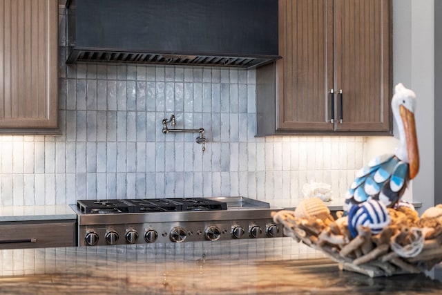 3835 Seabreeze Ln, Galveston, TX 77554 - kitchen featuring custom range hood, tasteful backsplash, stainless steel gas cooktop, and light countertops