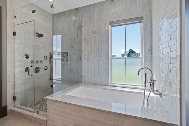3835 Seabreeze Ln, Galveston, TX 77554 - bathroom featuring healthy amount of natural light, a stall shower, and a garden tub