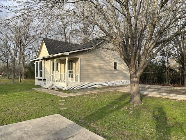 5919 Woodview Dr, Houston, TX 77396 - view of side of home featuring a yard, a porch, and roof with shingles