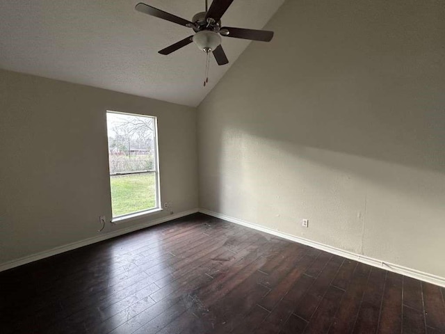 5919 Woodview Dr, Houston, TX 77396 - empty room with lofted ceiling, dark wood finished floors, baseboards, and a ceiling fan