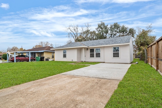 single story home with driveway, a front yard, and roof with shingles