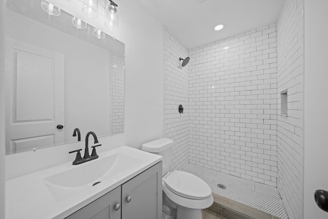 full bathroom with a shower stall, toilet, and vanity
