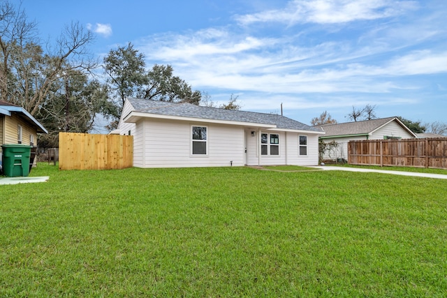 back of property with roof with shingles