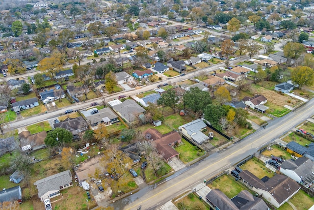 aerial view of property and surrounding area featuring nearby suburban area