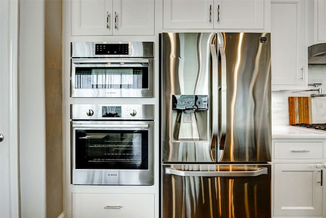 6003 Matthew Oaks Pl, Houston, TX 77007 - kitchen featuring appliances with stainless steel finishes, white cabinets, and light countertops