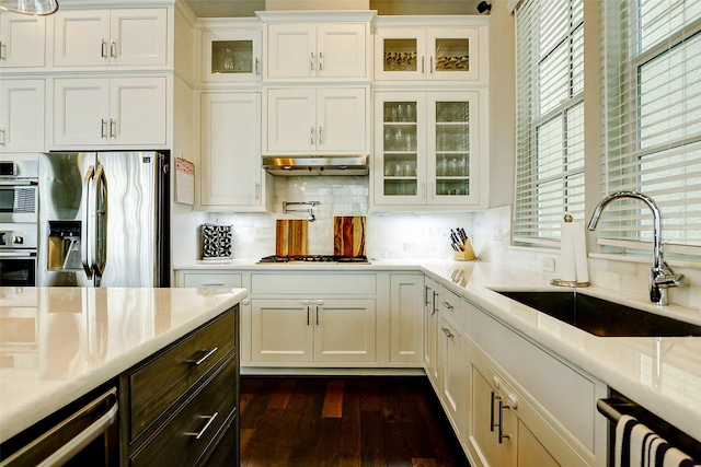 6003 Matthew Oaks Pl, Houston, TX 77007 - kitchen featuring stainless steel fridge with ice dispenser, white cabinetry, decorative backsplash, dark wood-type flooring, and glass insert cabinets
