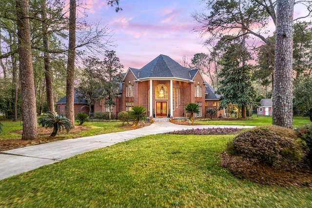 17511 Hawkin Ln, Tomball, TX 77377 - neoclassical / greek revival house featuring curved driveway, a yard, brick siding, and french doors
