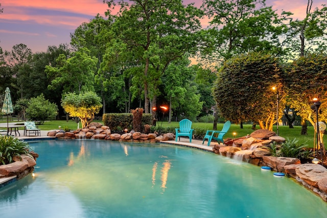 17511 Hawkin Ln, Tomball, TX 77377 - swimming pool featuring view of scattered trees, a lawn, and a patio area
