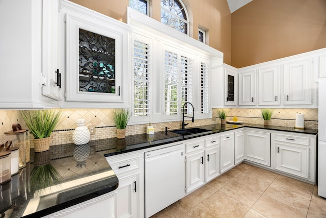 17511 Hawkin Ln, Tomball, TX 77377 - kitchen featuring white dishwasher, a sink, decorative backsplash, white cabinets, and high vaulted ceiling
