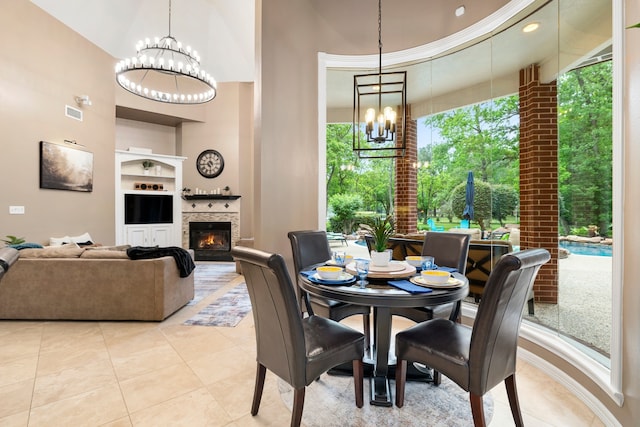 17511 Hawkin Ln, Tomball, TX 77377 - dining area featuring a chandelier, a glass covered fireplace, a towering ceiling, light tile patterned flooring, and built in features