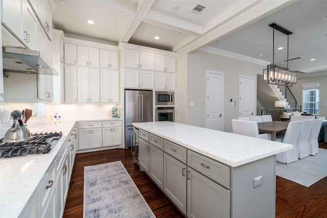 817 Blackshire Ln, Houston, TX 77055 - kitchen with appliances with stainless steel finishes, gray cabinetry, a center island, decorative backsplash, and recessed lighting