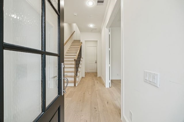 7506 Viano Ln, Houston, TX 77055 - hall with light wood-style floors, stairway, and ornamental molding