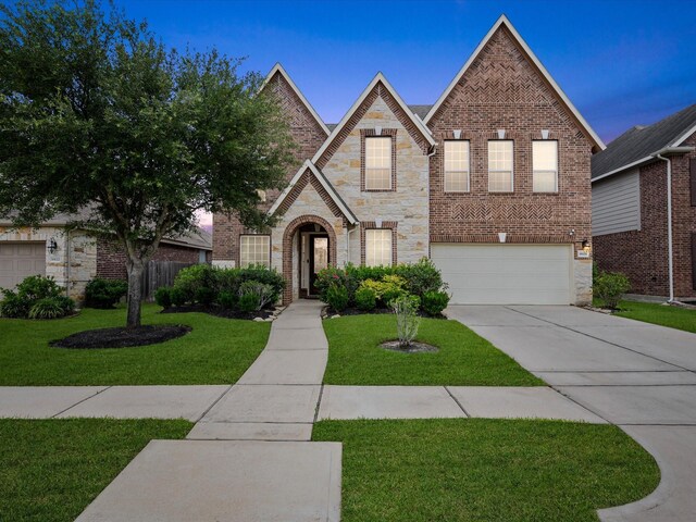18118 Berry Garden Ln, Spring, TX 77379 - view of front of property featuring a garage, driveway, stone siding, and brick siding