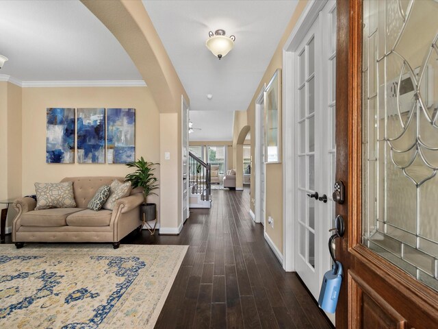 18118 Berry Garden Ln, Spring, TX 77379 - entrance foyer with arched walkways, baseboards, dark wood-style flooring, stairs, and ornamental molding