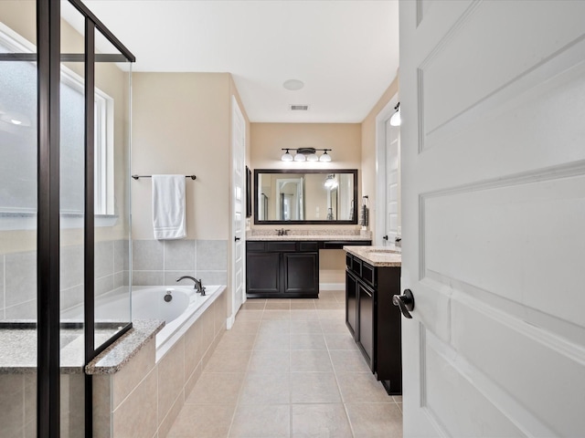 18118 Berry Garden Ln, Spring, TX 77379 - full bath featuring a garden tub, tile patterned floors, and vanity