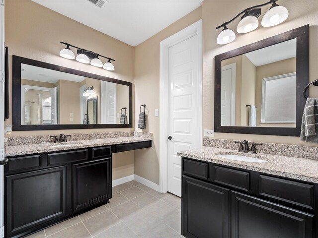 18118 Berry Garden Ln, Spring, TX 77379 - full bathroom featuring tile patterned floors, two vanities, and baseboards