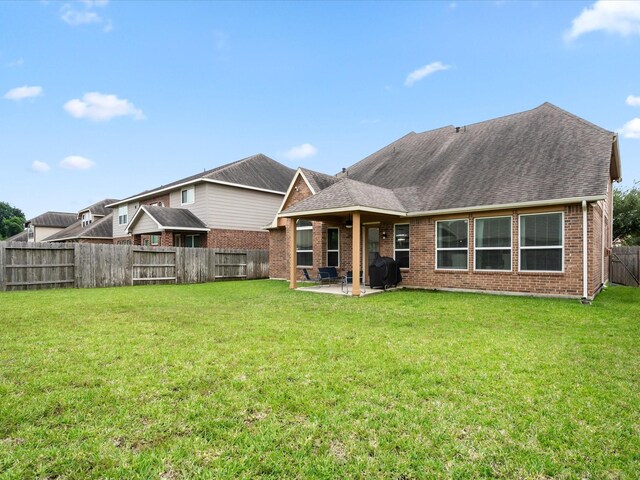 18118 Berry Garden Ln, Spring, TX 77379 - rear view of property featuring a patio area, a shingled roof, and brick siding