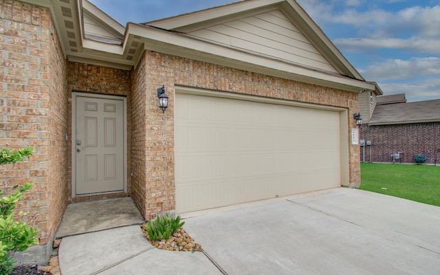 6002 Purple Iris St, Katy, TX 77449 - view of exterior entry featuring brick siding, driveway, and a garage