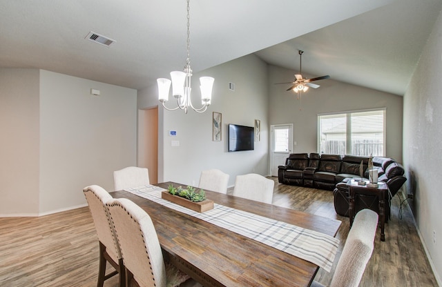 6002 Purple Iris St, Katy, TX 77449 - dining area with light wood-type flooring, vaulted ceiling, a chandelier, a ceiling fan, and baseboards
