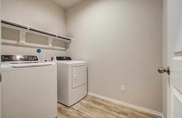 6002 Purple Iris St, Katy, TX 77449 - laundry area featuring washer and dryer, light wood finished floors, and baseboards