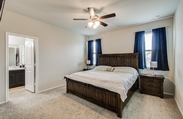 6002 Purple Iris St, Katy, TX 77449 - bedroom with light colored carpet, baseboards, ceiling fan, and ensuite bath