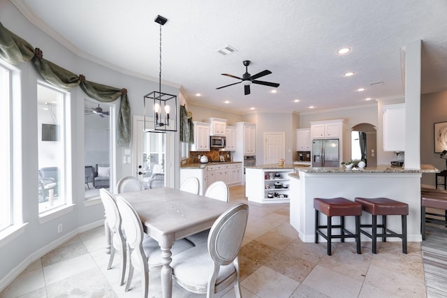 3907 Movado Ct, Spring, TX 77386 - dining area featuring ceiling fan, ornamental molding, arched walkways, recessed lighting, and baseboards