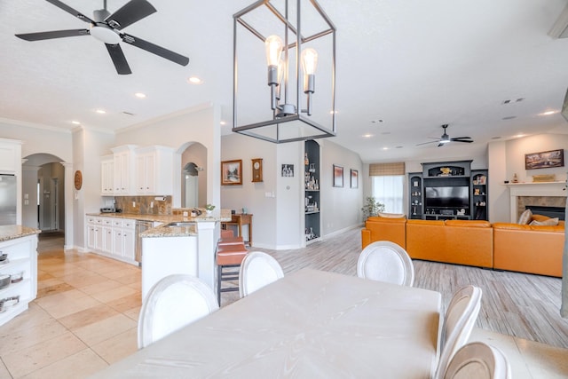 3907 Movado Ct, Spring, TX 77386 - dining area with ceiling fan, arched walkways, baseboards, ornamental molding, and recessed lighting