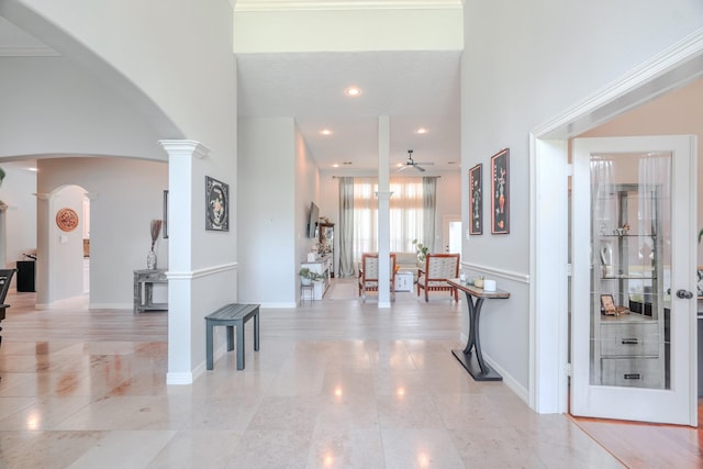3907 Movado Ct, Spring, TX 77386 - hallway with decorative columns, arched walkways, light tile patterned flooring, a towering ceiling, and recessed lighting