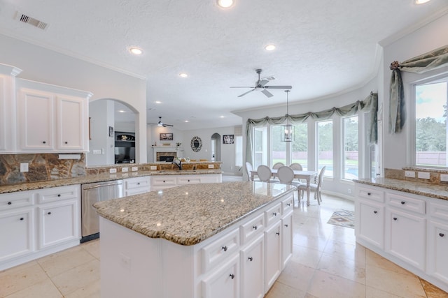 3907 Movado Ct, Spring, TX 77386 - kitchen with dishwasher, a ceiling fan, arched walkways, crown molding, and tasteful backsplash