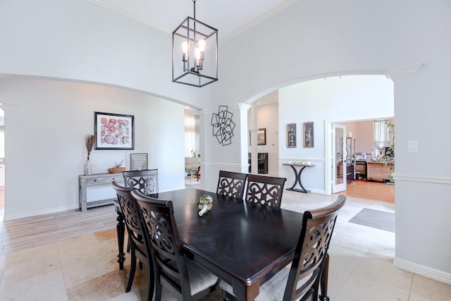 3907 Movado Ct, Spring, TX 77386 - dining space featuring arched walkways, decorative columns, ornamental molding, baseboards, and a high ceiling