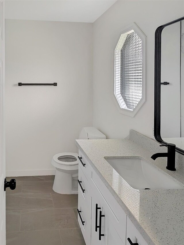 10938 Fleming Dr, Houston, TX 77013 - bathroom with vanity, toilet, and baseboards