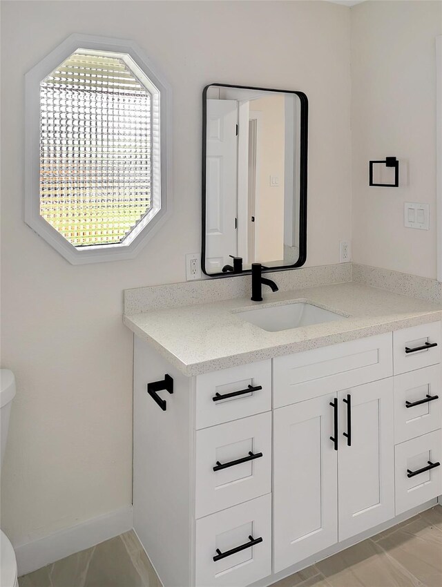 10938 Fleming Dr, Houston, TX 77013 - bathroom featuring toilet, vanity, and baseboards