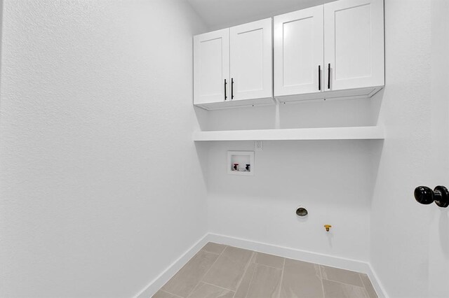 10938 Fleming Dr, Houston, TX 77013 - laundry room with cabinet space, baseboards, and washer hookup