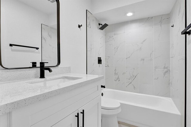 10938 Fleming Dr, Houston, TX 77013 - full bath featuring vanity, toilet, shower / washtub combination, and recessed lighting