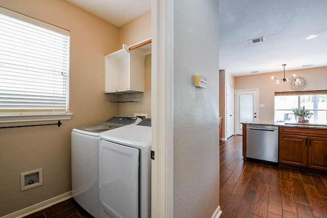20815 Winlock Trace Dr, Katy, TX 77450 - washroom with separate washer and dryer, baseboards, dark wood finished floors, and a chandelier