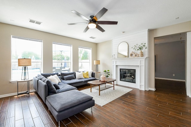 20815 Winlock Trace Dr, Katy, TX 77450 - living area with dark wood-style flooring, ceiling fan, baseboards, and a tiled fireplace