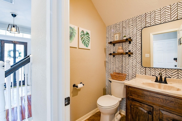 20815 Winlock Trace Dr, Katy, TX 77450 - half bath featuring vanity, toilet, wallpapered walls, lofted ceiling, and baseboards