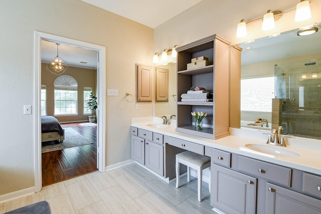 20815 Winlock Trace Dr, Katy, TX 77450 - full bathroom featuring double vanity, a shower stall, baseboards, and connected bathroom