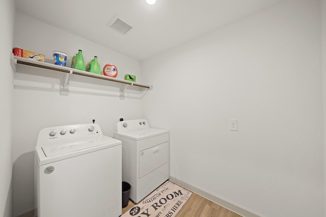 1103 Curly Angora Ct, Rosharon, TX 77583 - laundry area featuring washing machine and clothes dryer, light wood-style flooring, and baseboards