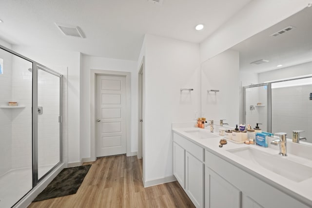 1103 Curly Angora Ct, Rosharon, TX 77583 - full bathroom with a shower stall, wood finished floors, double vanity, and baseboards