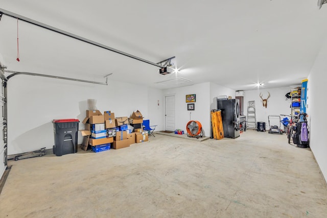 19015 Giara Pony Trl, Tomball, TX 77377 - garage with freestanding refrigerator and a garage door opener
