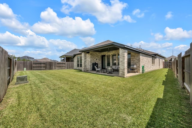19015 Giara Pony Trl, Tomball, TX 77377 - back of property featuring brick siding, a patio area, a fenced backyard, and ceiling fan