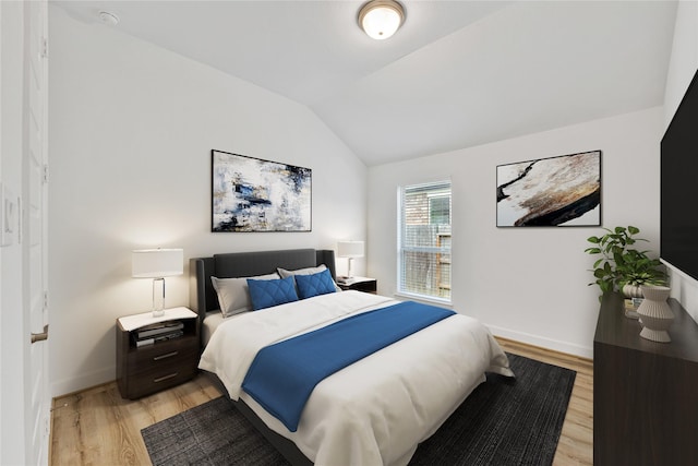 19015 Giara Pony Trl, Tomball, TX 77377 - bedroom featuring light wood-style flooring and vaulted ceiling