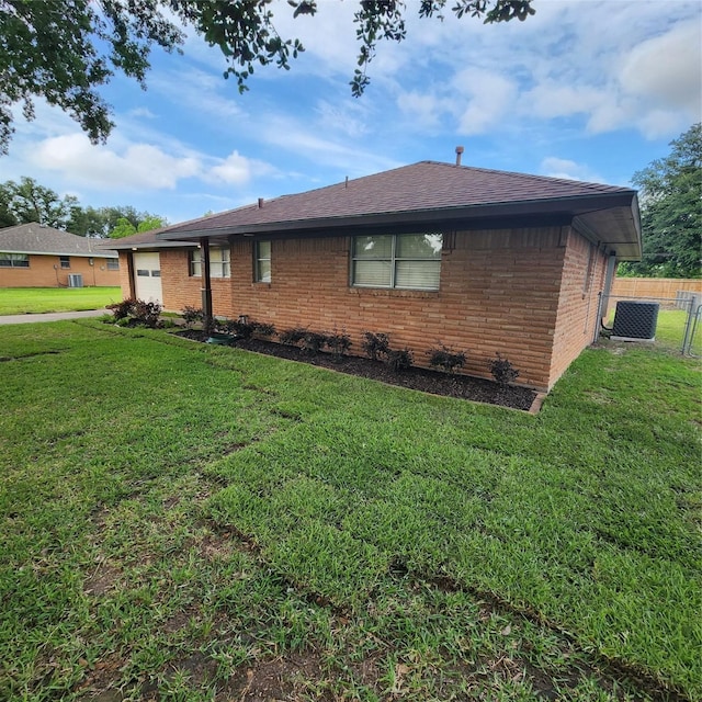 3625 Whatley Dr, Deer Park, TX 77536 - view of side of property with a garage, brick siding, central AC, and roof with shingles