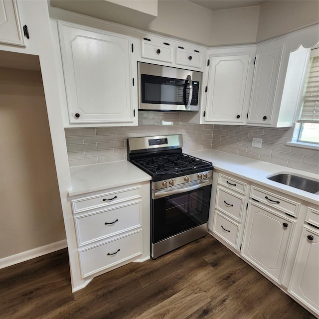 3625 Whatley Dr, Deer Park, TX 77536 - kitchen featuring stainless steel appliances, white cabinetry, dark wood-style floors, and light countertops